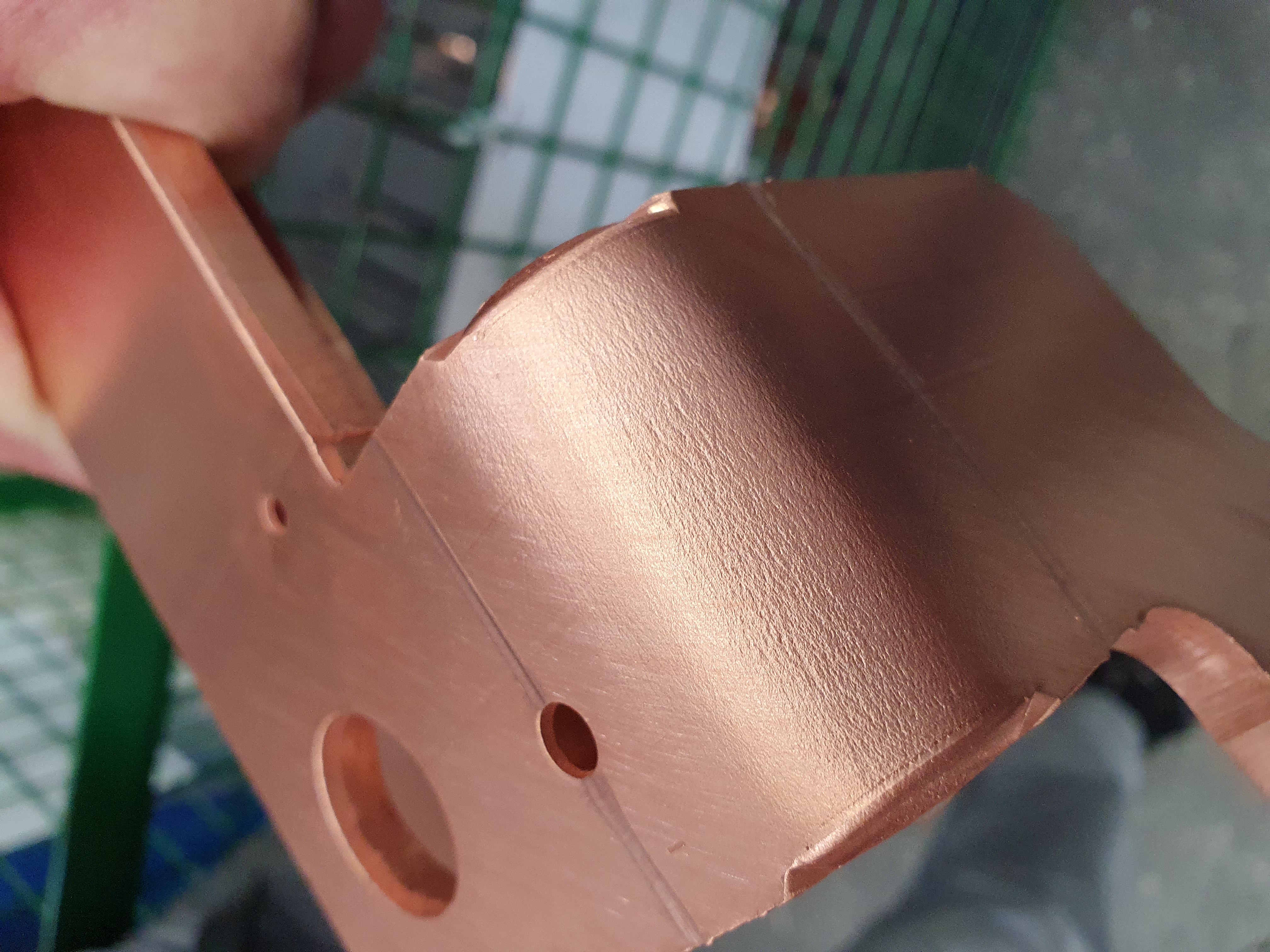 A copper piece with bending cracks