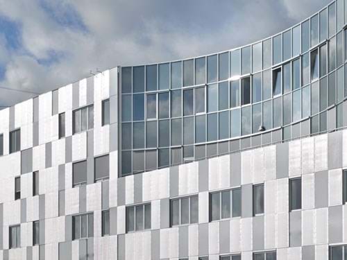 Urban facade near the sea with untreated aluminium cladding